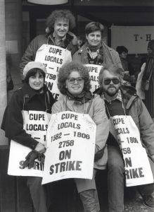 The union leadership of the Metro Library Strike organized fun days on the picket lines as a creative way to attract attention, win support and build pressure on the politicians responsible for running the library. Here members of CUPE Local 1582 watch the poets and singers on the arts and letters solidarity picket, acknowledging the work of the Music and Fine Arts departments. Front row left to right: M. Gordon, Susan Willis, Gerry Haley. Back row Bob Adams, Susan Reed