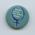 A button drawing attention to women artists.