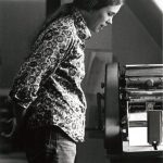 Cathy Carroll, now Billie Carroll, working on office Gestetner at the Women's Press office on Bloor Street West in Toronto. Photo from between 1972-1976. Photograph by Janice Acton.