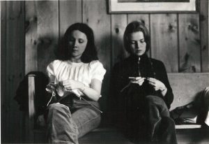 Photo of Genevieve Leslie and Bonnie Ward (now Bonnie Shepherd) knitting while at Women's Press retreat north of Toronto. Photo dates from between 1972 and 1976. Photograph by Janice Acton.