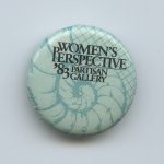 The button was made for a 1983 art exhibit from a "woman's perspective" held at the Partisan Gallery in Toronto.