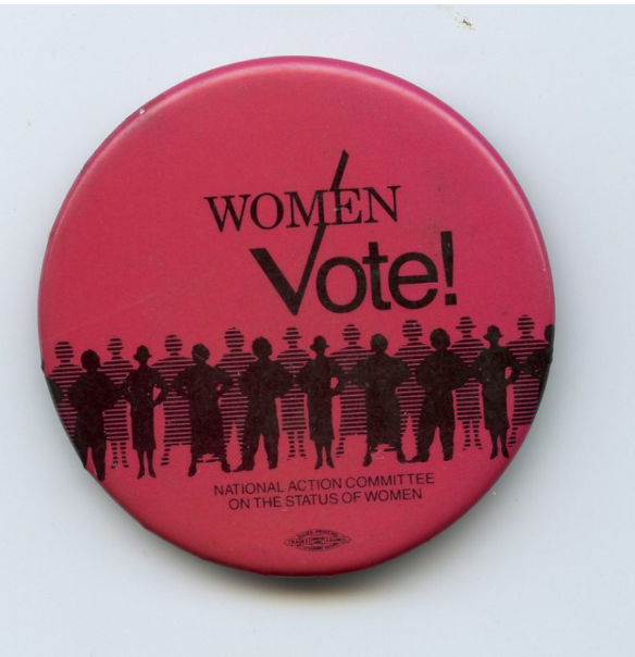 A bright pink button with silhouettes of a crowd of people below the words 'WOMEN VOTE!'